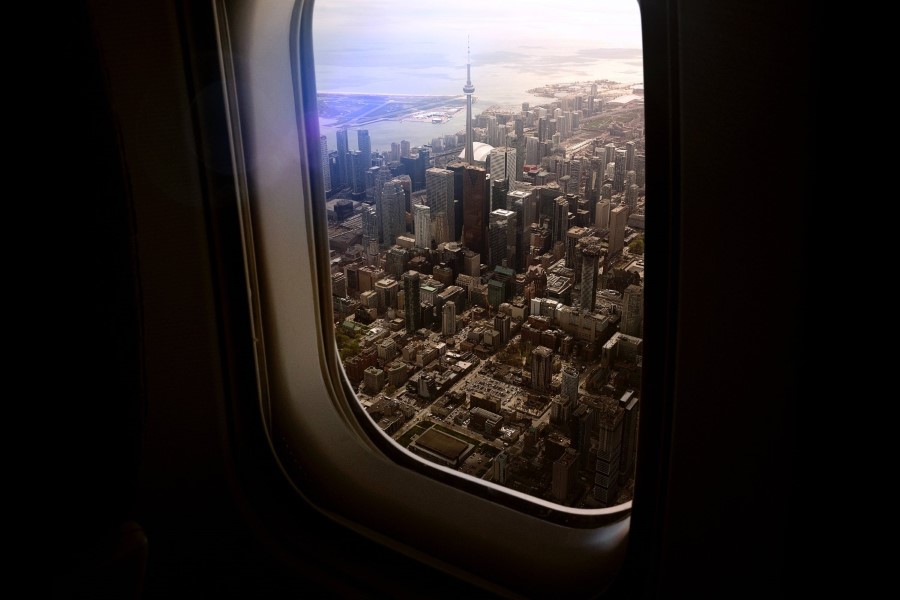 airplane window looking over a city